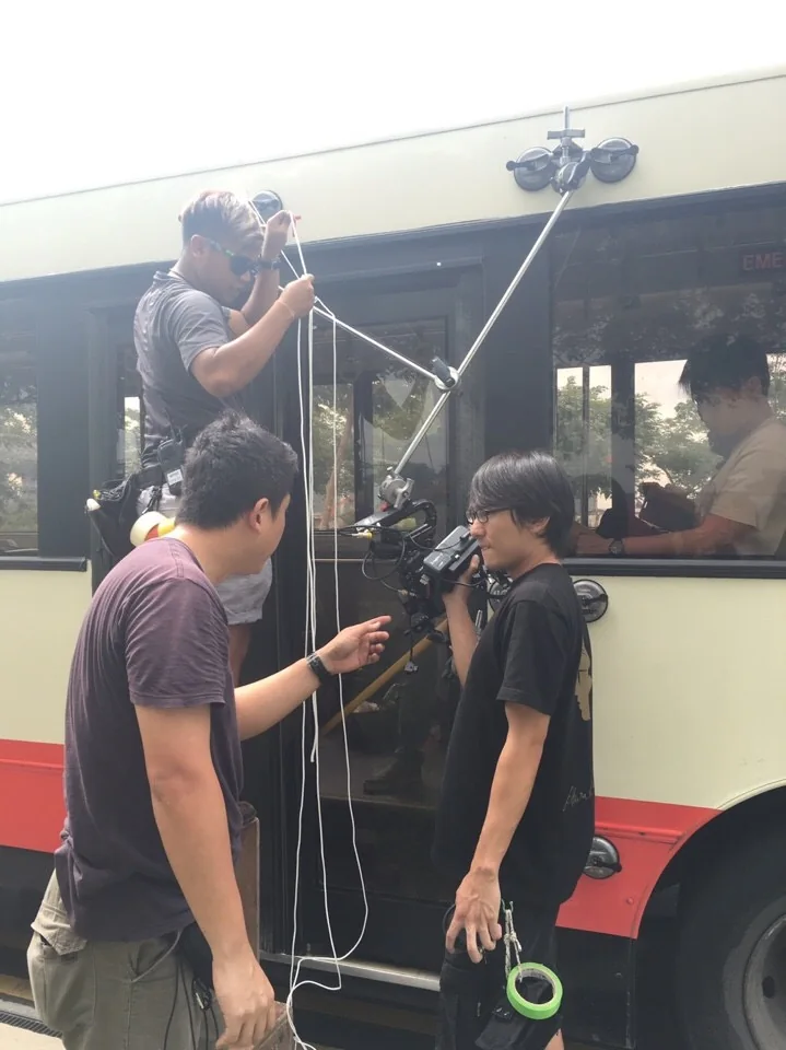 Cast and crew at work during the bus production.
