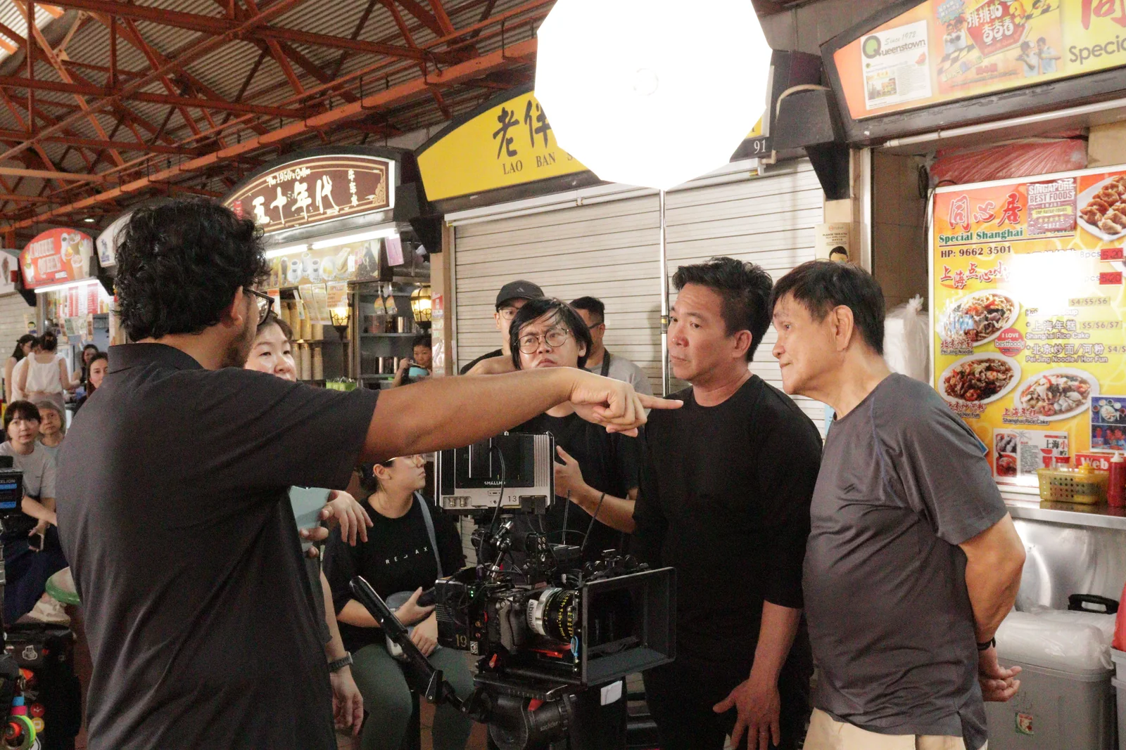 Gilbert working with the camera team on set.