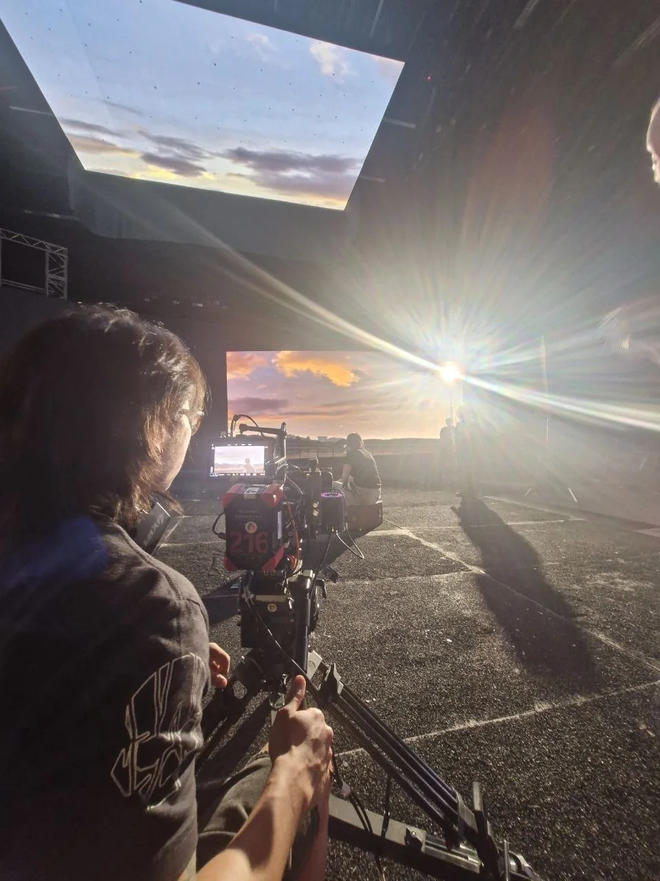 Camera operator framing a scene on a Red Ink production.