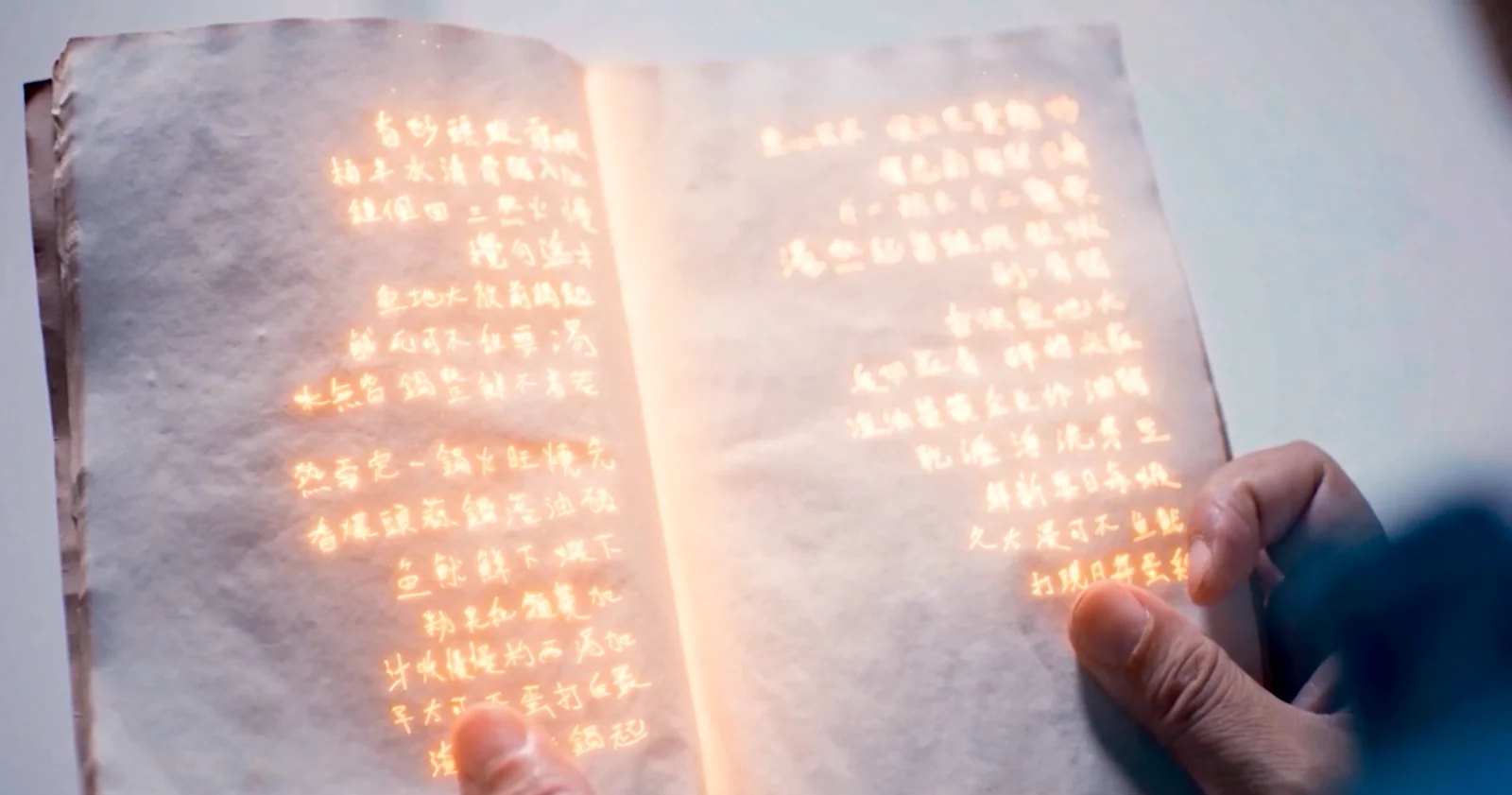 Warm golden light glows from the open recipe book in The Time Travelling Hawker.